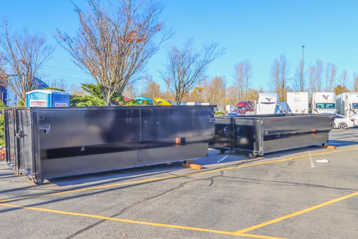 Professional dumpster rental service with roll-off container on residential driveway in Easttown